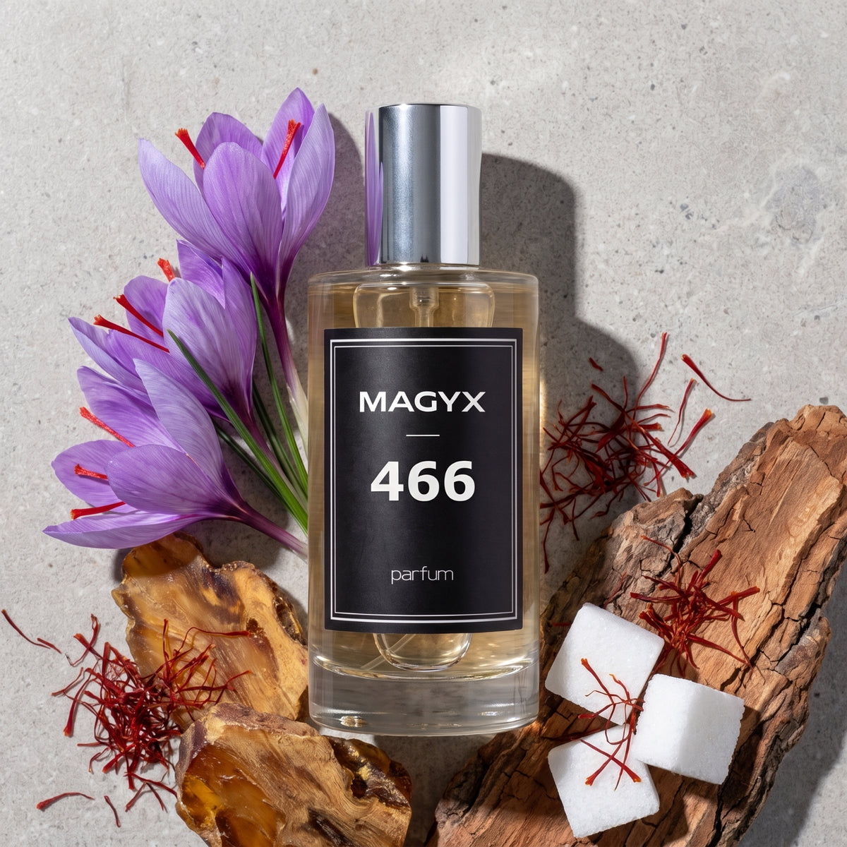 Official Magyx No. 466 perfume surrounded by saffron and woody fragrance ingredients
